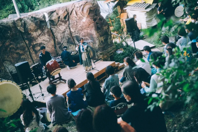 An outdoor live performance of Japanese musical instruments held in the forest