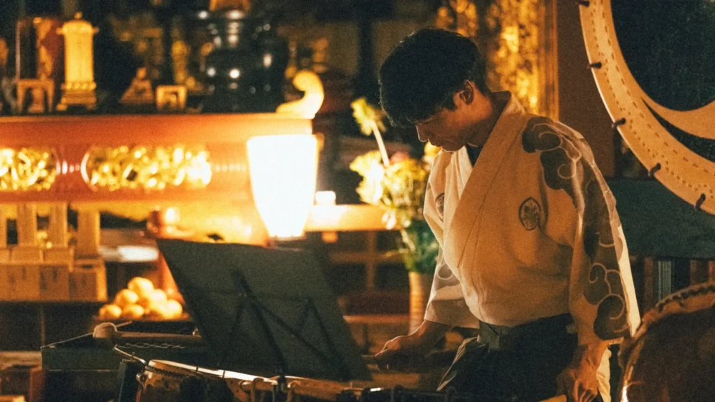 Professional taiko drummer performing at a temple