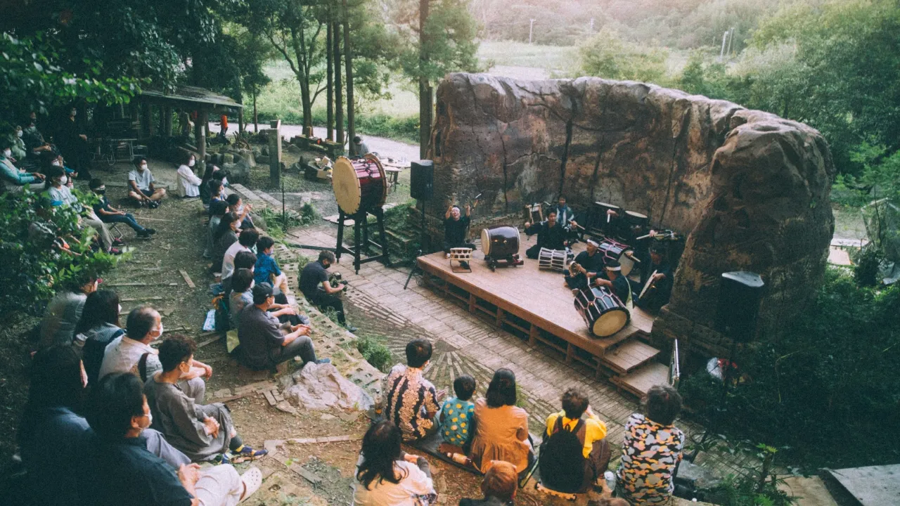 Scene from an outdoor live performance of traditional Japanese instruments