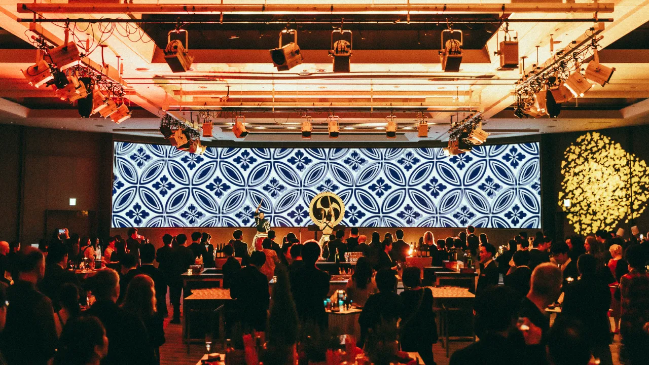 Japanese taiko drummers performing in front of a large audience