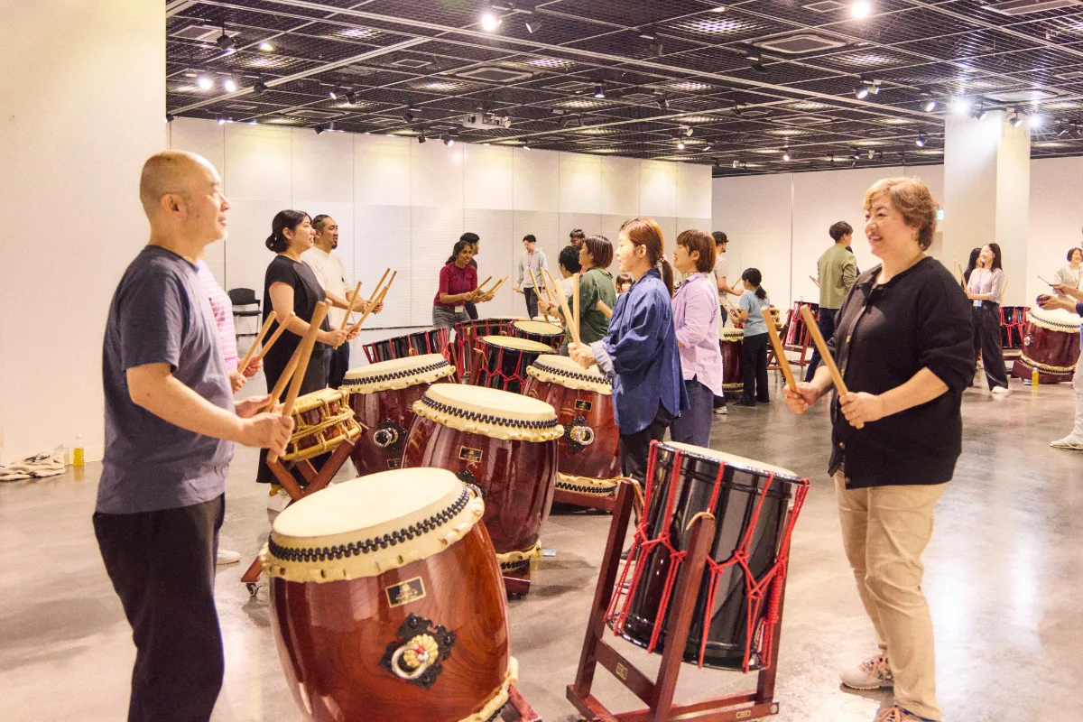 Employees participating in a corporate taiko drumming workshop during a company event