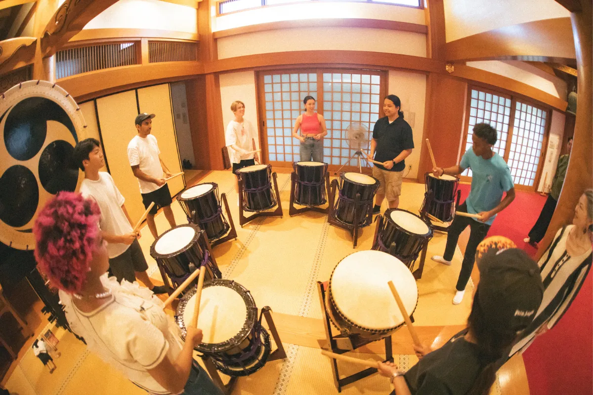 Employees enjoying team building with colleagues through taiko drumming activities