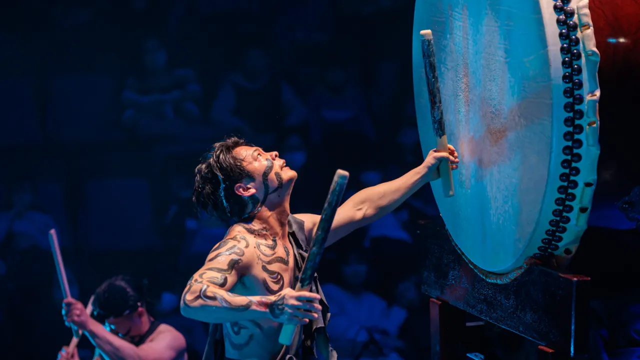 Avant-garde performance featuring Japanese taiko drums and traditional musical instruments, blending art and culture in a powerful live show.