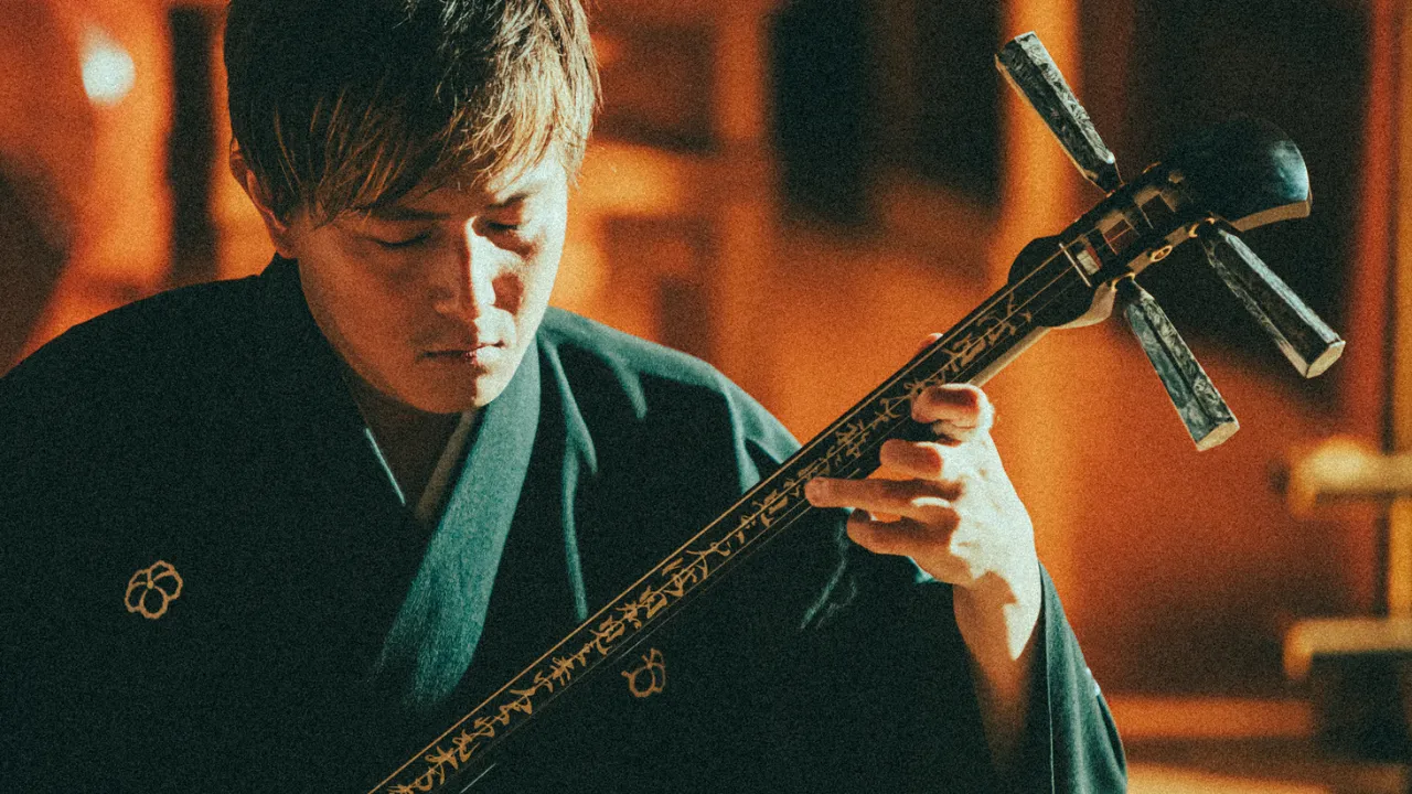 Live shamisen and traditional Japanese music performance at a Buddhist temple in Tokyo, showcasing cultural artistry in an authentic setting.