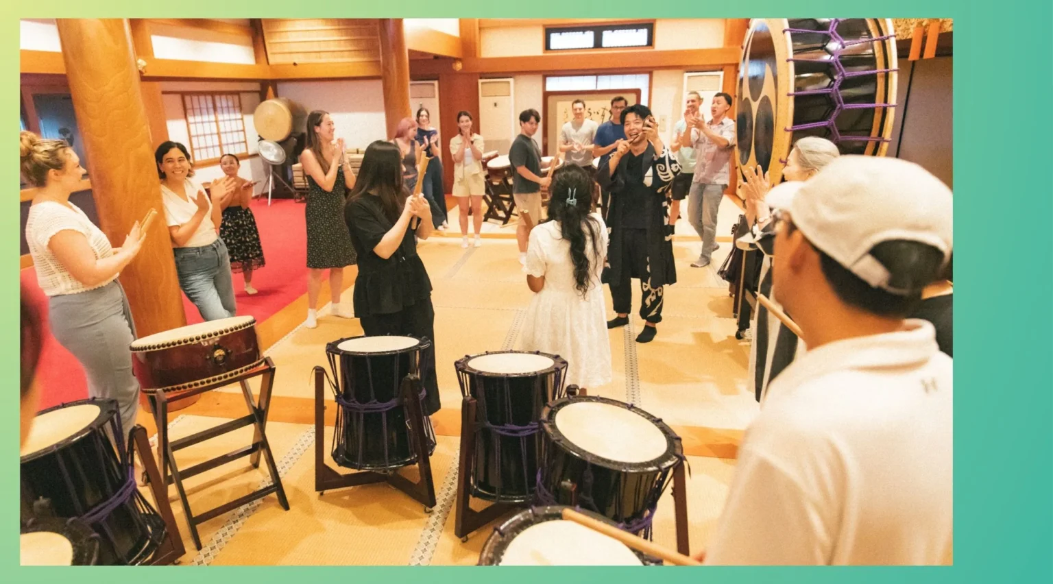 Smiling participants at a taiko drum workshop, a memorable moment from a corporate team building event held in Tokyo