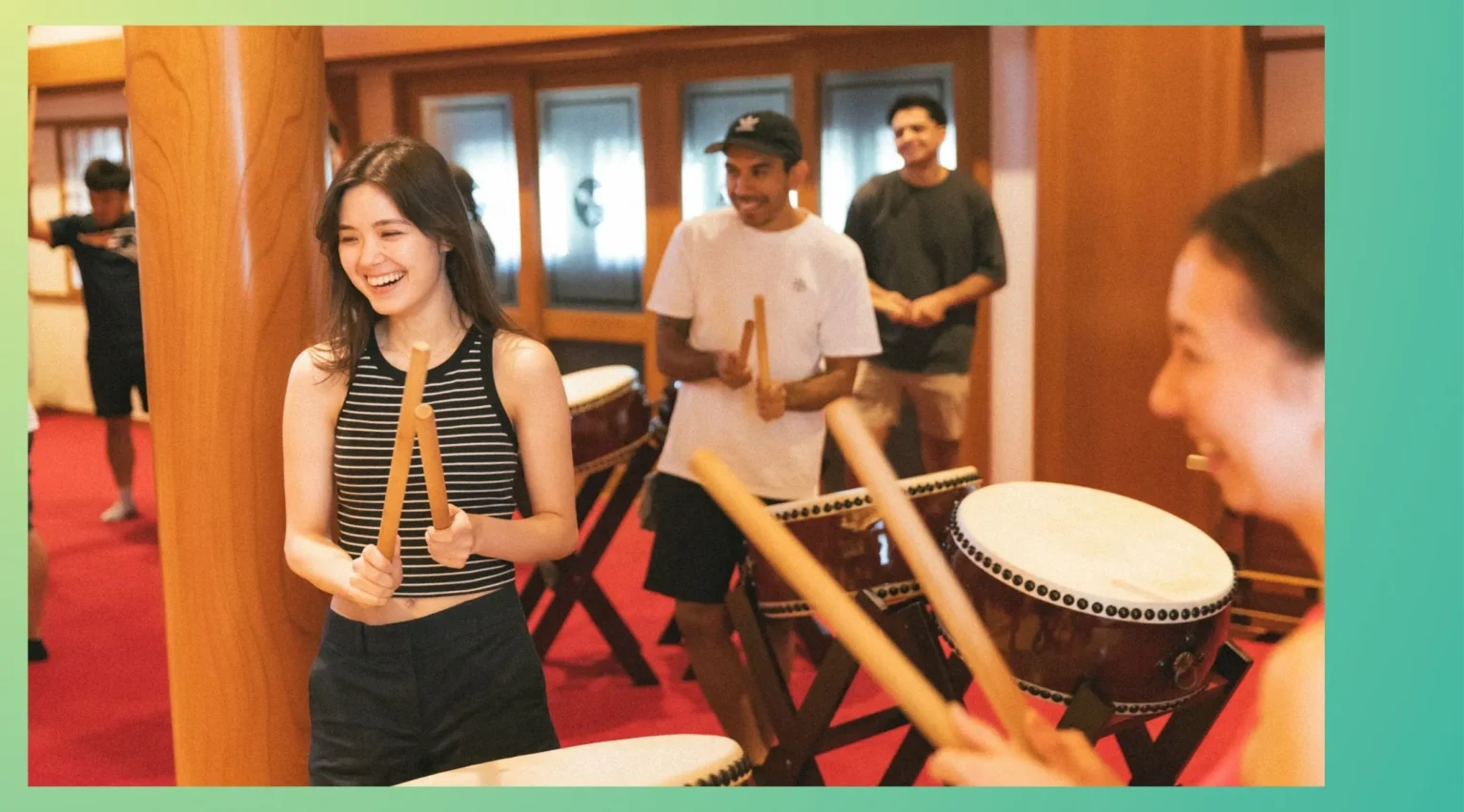 Happy corporate team members joining a Japanese cultural taiko drum activity as a team building experience