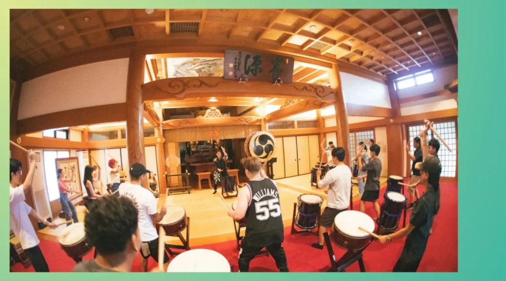 Corporate team building training held at a temple in Tokyo, with employees taking part in a Japanese taiko cultural activity