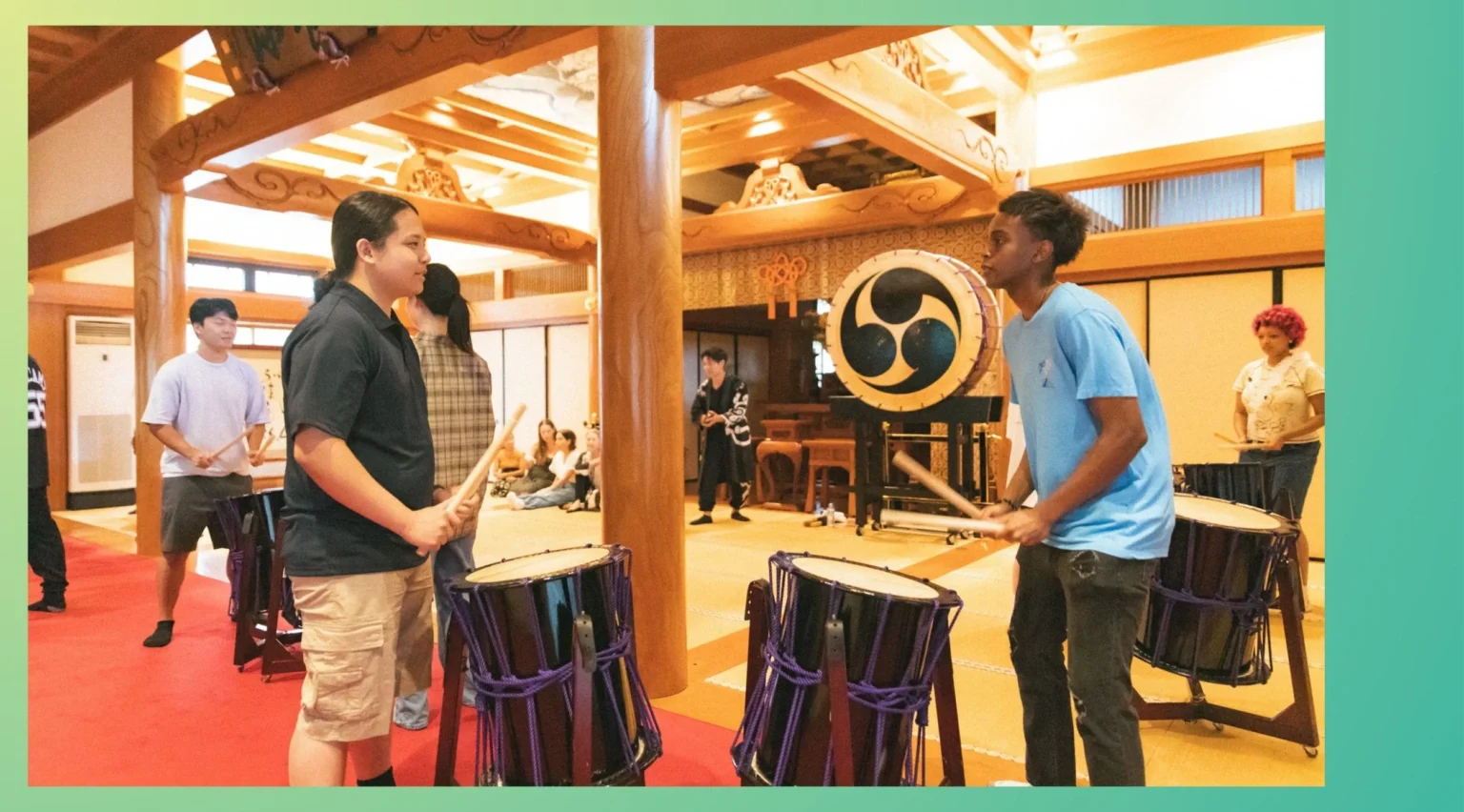 Two-person corporate team building activity, with employees energizing their communication through a taiko drum pair game