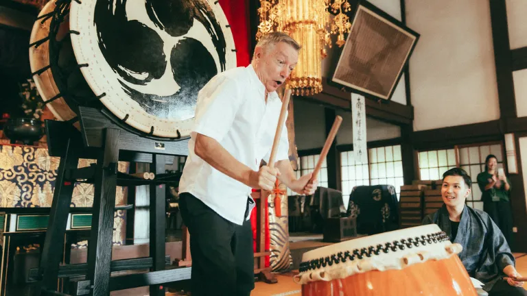 Company president communicating with team members through Japanese taiko drums